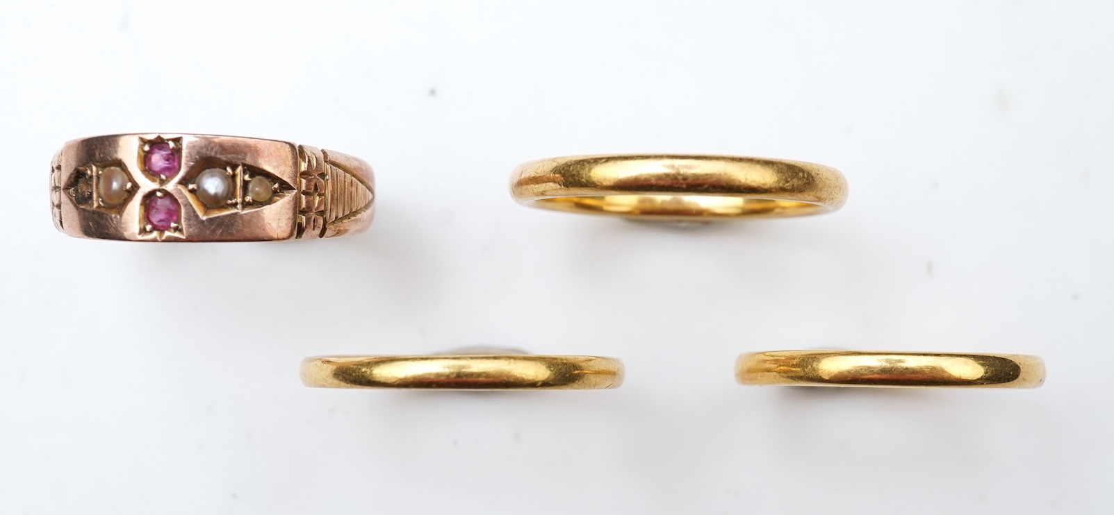 A collection of four gold rings